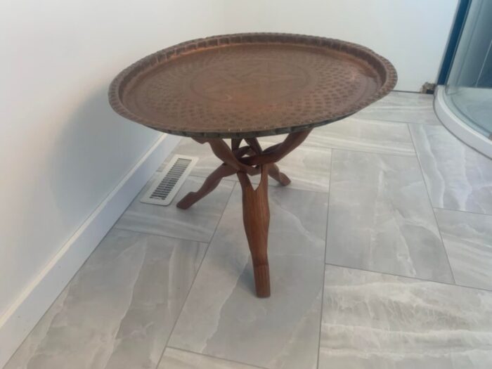 1960s moroccan hand worked copper tray with carved teak tripod base 2207