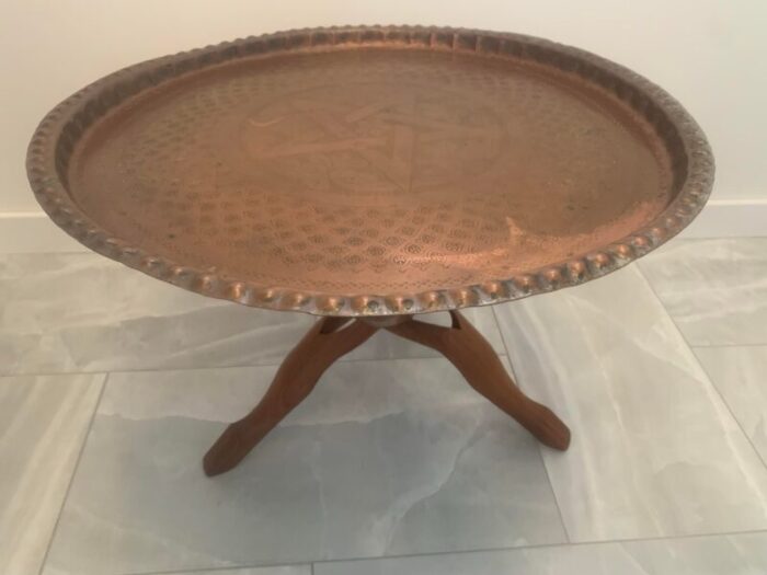 1960s moroccan hand worked copper tray with carved teak tripod base 8395