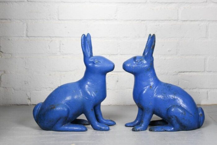 antique sculptural figural blue painted cast iron rabbit doorstops set of 2 1