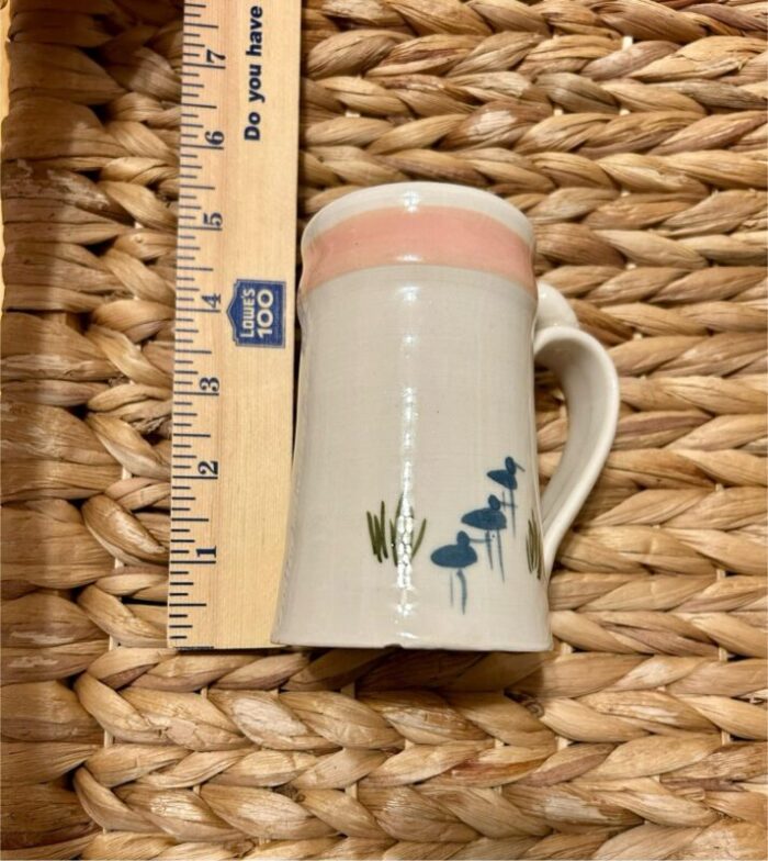 set of 2 jan mann signed and dated tea coffee mugs north carolina pottery with bird scenes stork and egret in soft blues light pink 2083