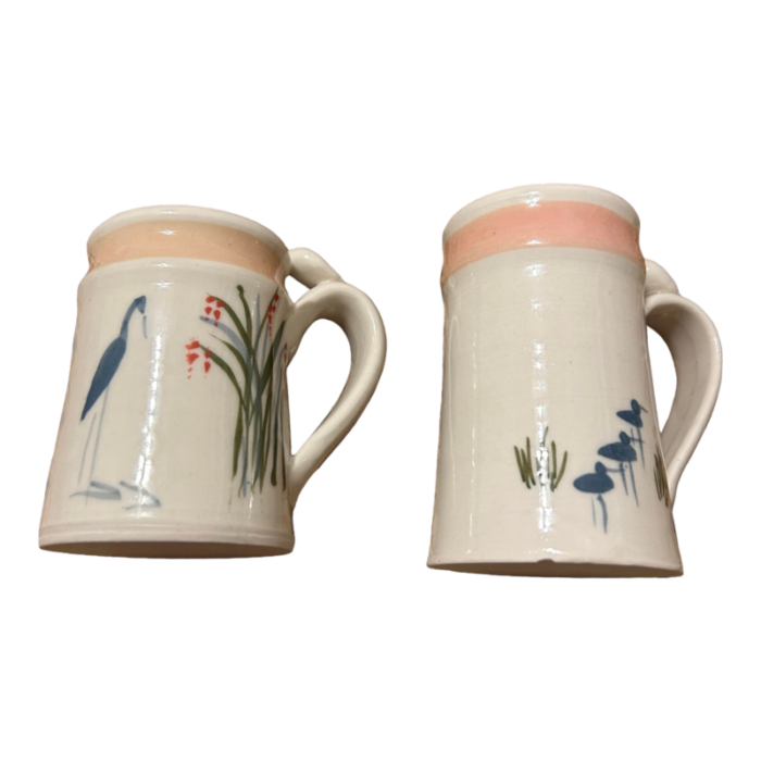 set of 2 jan mann signed and dated tea coffee mugs north carolina pottery with bird scenes stork and egret in soft blues light pink 8566